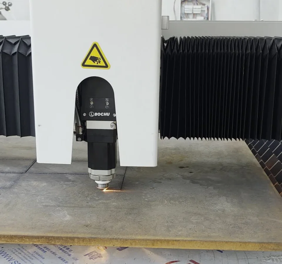 Laser cutting head working over sheet material.